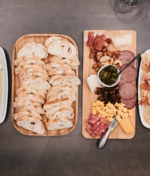 Top view of a gourmet charcuterie board with cured meats, cheeses, and sliced bread, perfect for gatherings.